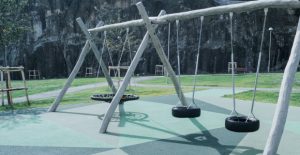 Playground with swings - Safety surfacing made with Rubber coloured granulate